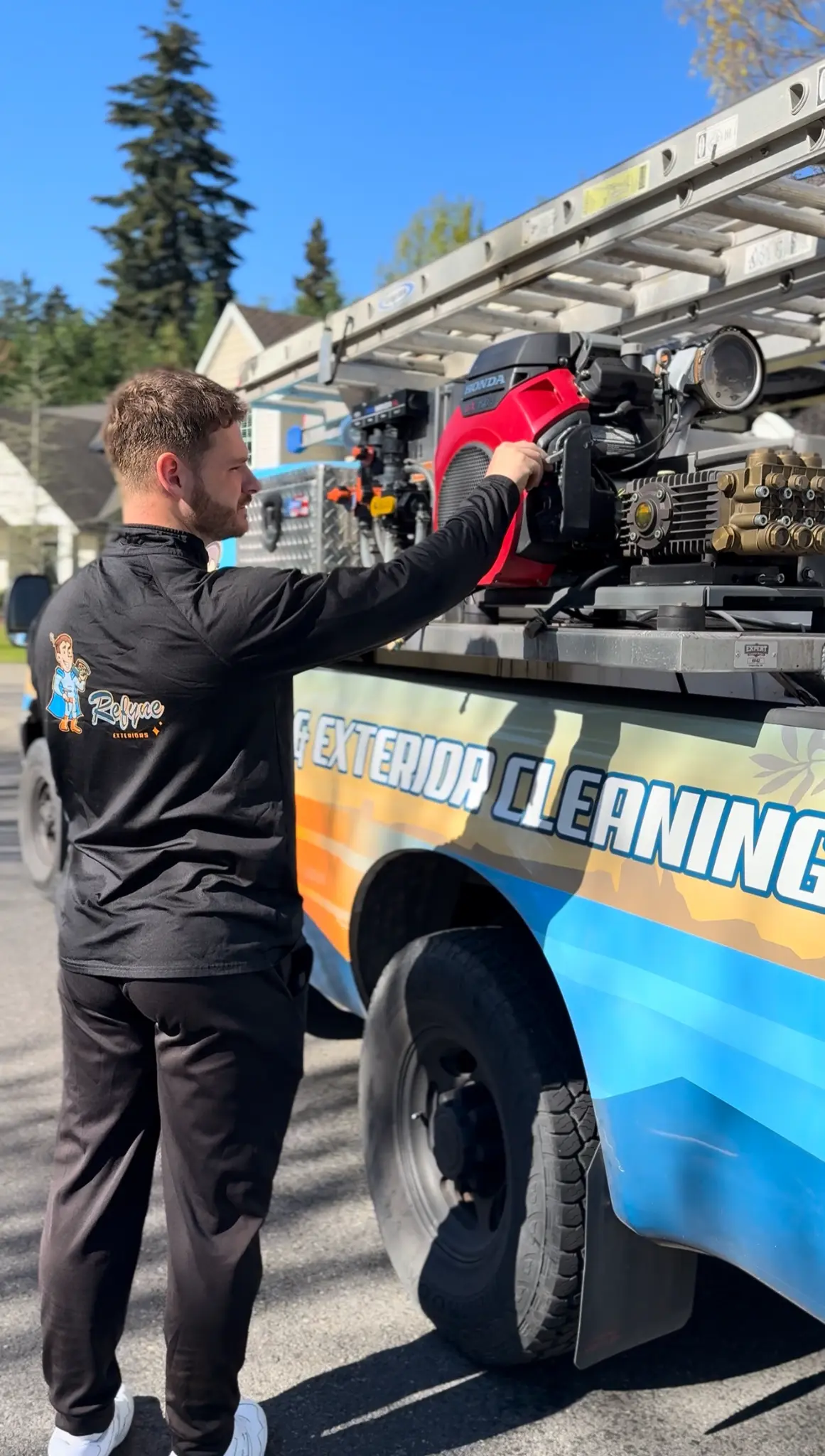 Refyne Window Cleaning technician preparing pressure washing equipment